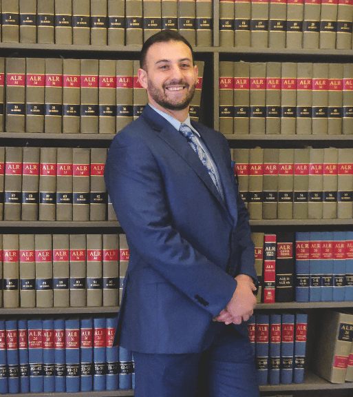 Thomas Spiro Conits, Greenville personal injury attorney, in the law library in front of the American Law Reports volumes